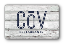 COV Restaurants logo in blue over a wooden background.